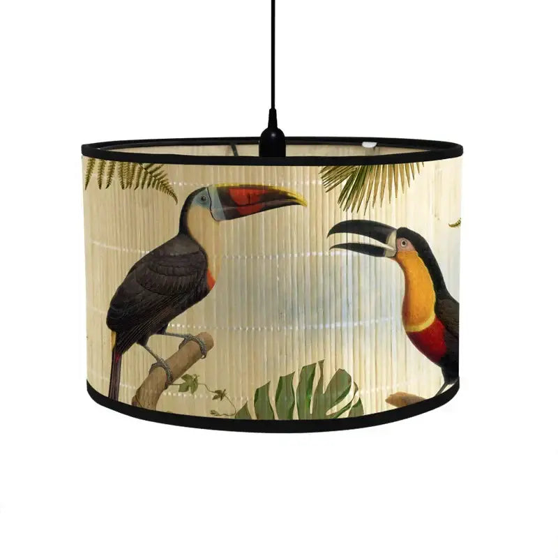 A beige fabric decorbites bamboo pendant light with toucan illustrations and tropical foliage for dining room decor