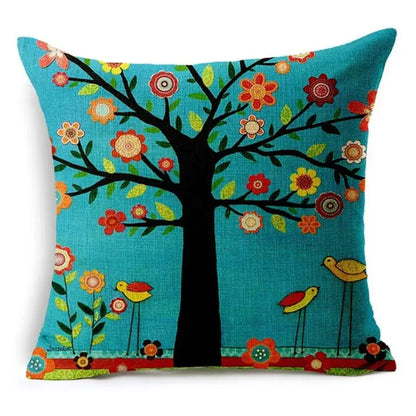 Turquoise throw pillow with black tree, colorful flowers, yellow birds, and green leaves decorative design for home decor