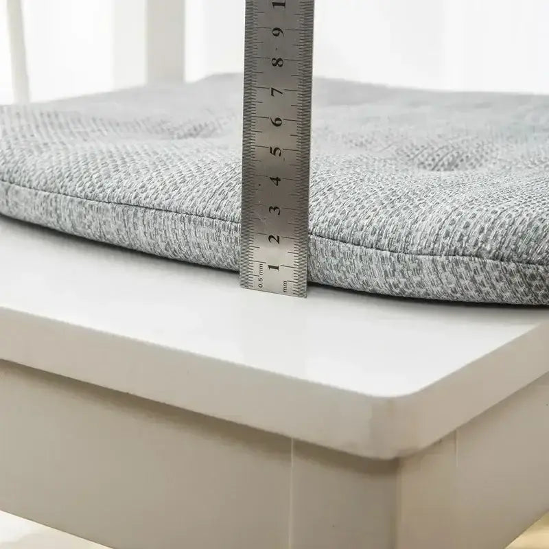 Gray textured chair cushions with tufted design and metallic ruler for measurement in decorbites dining chair set
