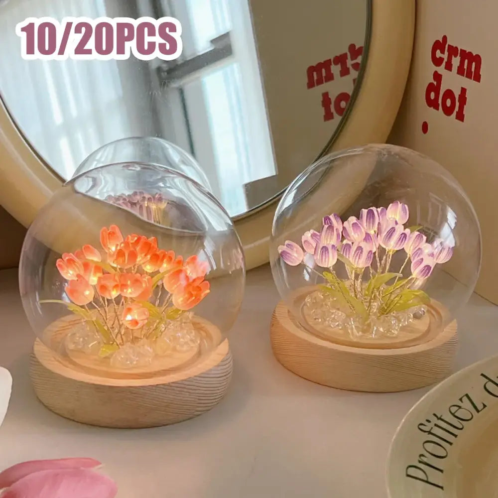 Clear glass dome tulip night light with illuminated orange and purple tulips on wooden bases for bedside use