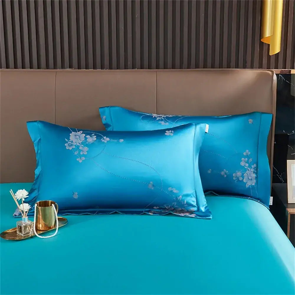 Turquoise blue satin jacquard bedding set featuring vibrant blue satin pillowcases with delicate white floral embroidery