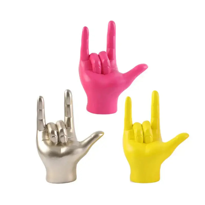 Vibrant abstract hand love sculpture in pink metallic silver and neon yellow as rock gesture living room decorbites decor