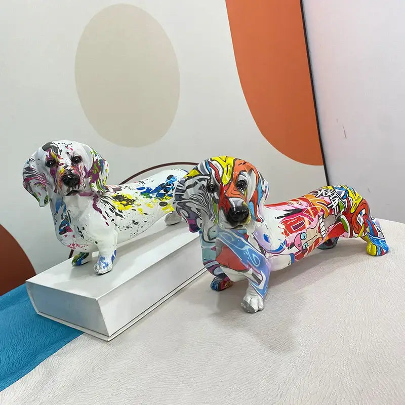 Two vibrant graffiti art decorbites dachshund dog resin figurines with colorful paint splatters for living room decor