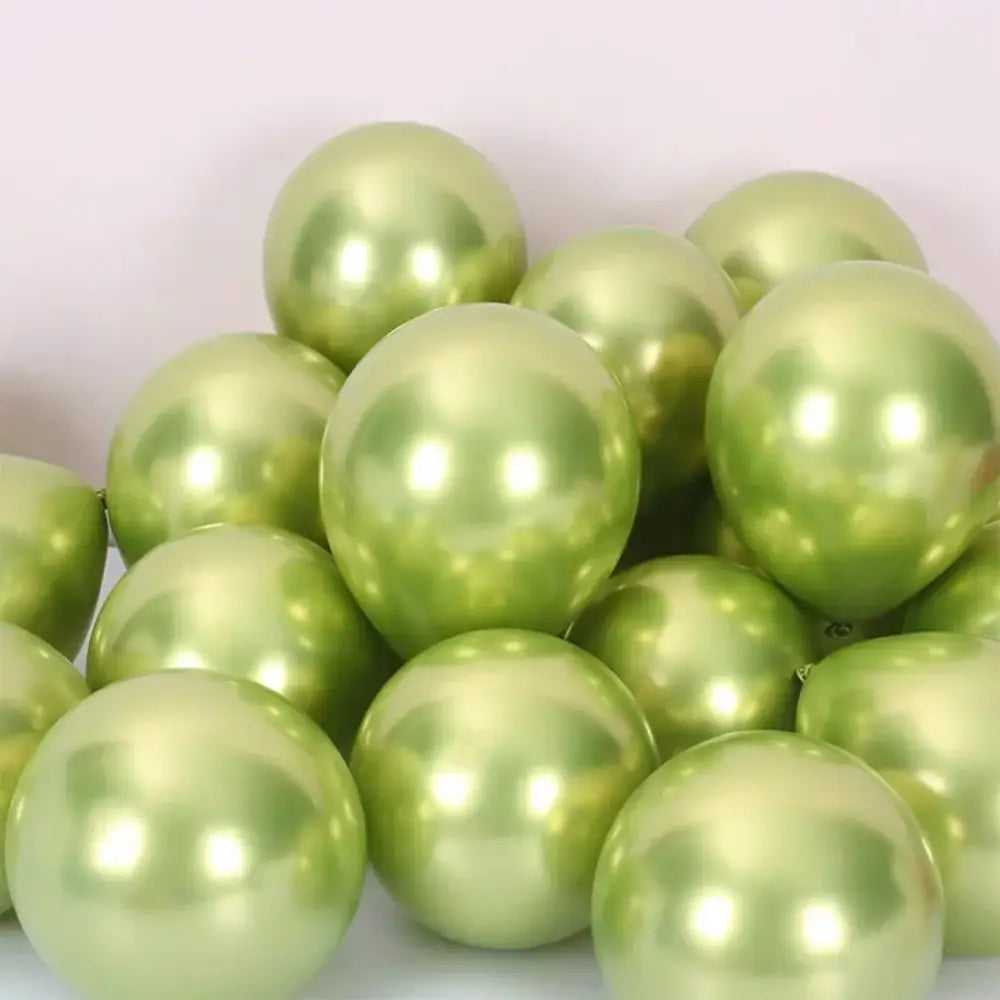 A pile of shiny metallic sage green latex confetti balloons with a pearlescent finish for party decor