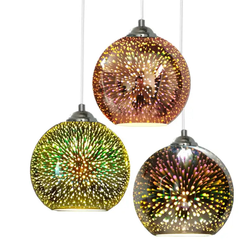 Three spherical glass pendant light fixtures with iridescent starburst patterns in amber and green for living room