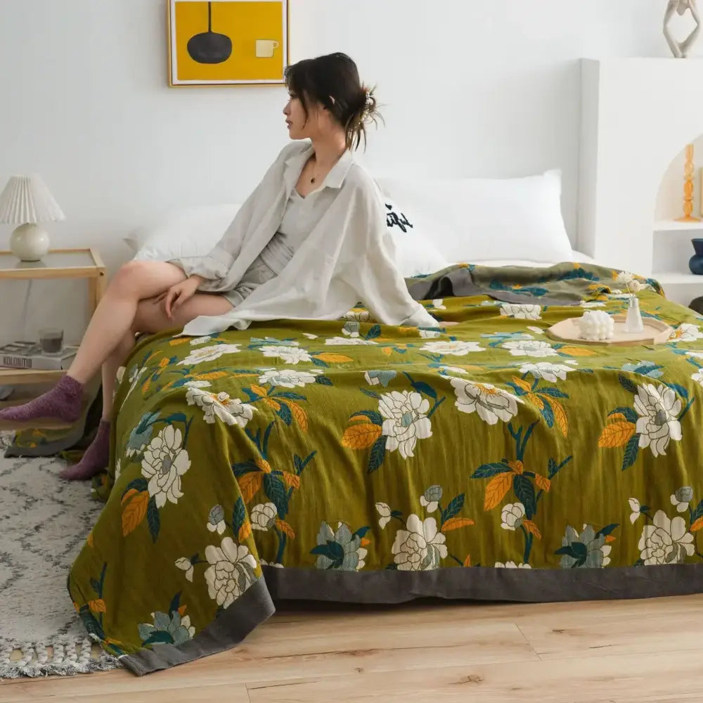 Olive green floral throw blanket with white and yellow blossoms and gray border for vibrant nordic bedroom decor