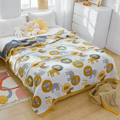 A soft white nordic throw blanket with playful lions and elephants pattern and a mustard yellow border