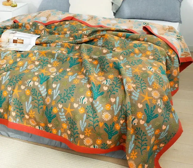 Cozy olive green throw blanket with vibrant underwater pattern and bold red trim perfect as a nordic throw blanket