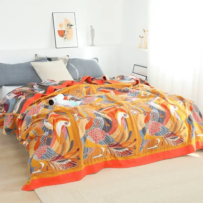 Vibrant orange and red bird-patterned nordic throw blanket with soft textured fabric for bedroom bedspread use