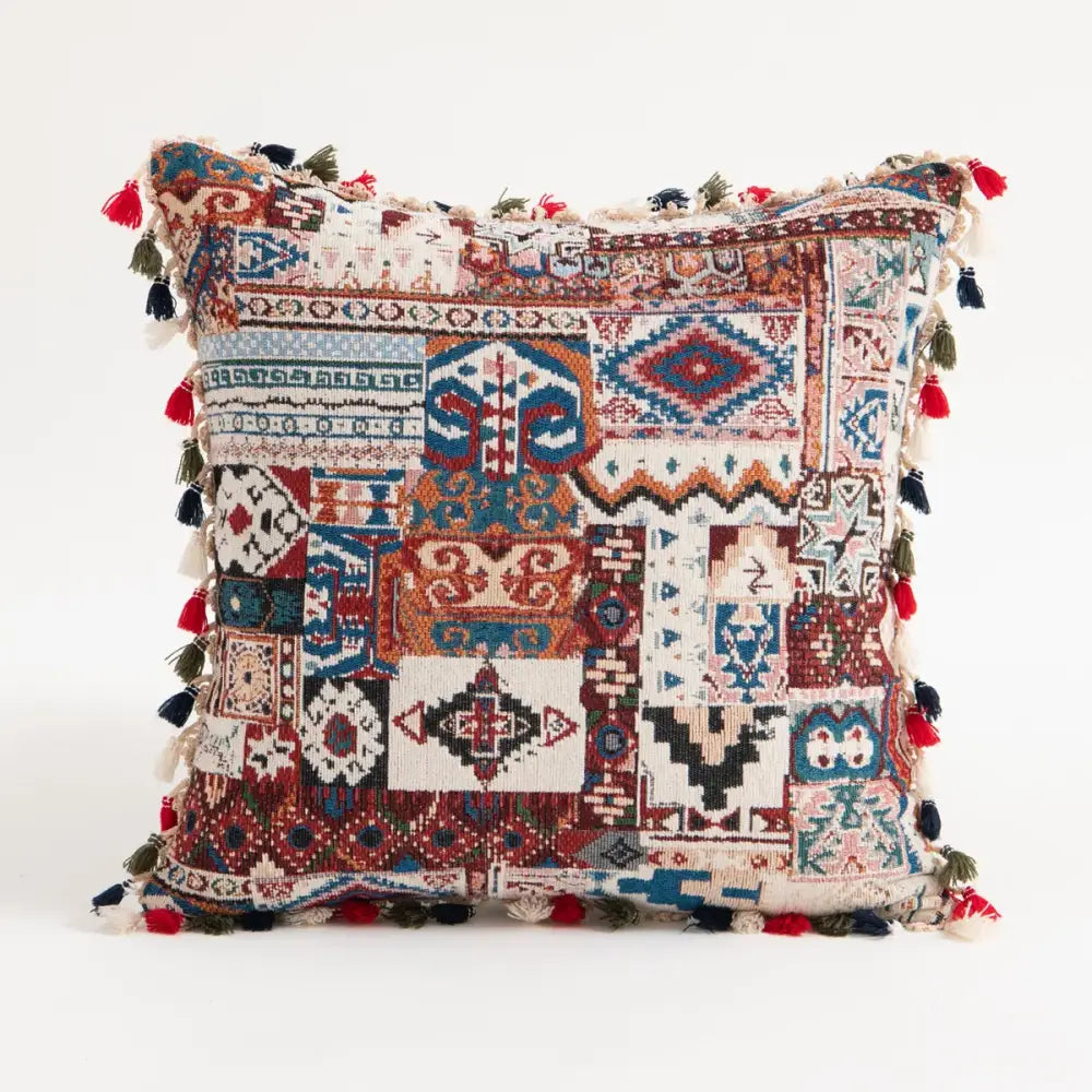 Vibrant patchwork ethnic boho pillow cover with intricate geometric patterns and multicolored tassels for living room decor