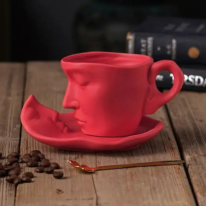 Vibrant red frosted ceramic face mug set by decorbites featuring sculpted design on coffee cup and matching saucer