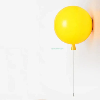 A vibrant yellow balloon lamps wall light with sleek minimalist design for bedroom use