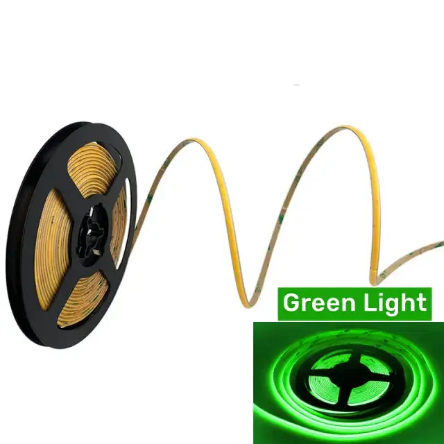 A flexible green vibrant slim 4mm cob led strip light coiled on a black spool with visible circuitry and adhesive backing