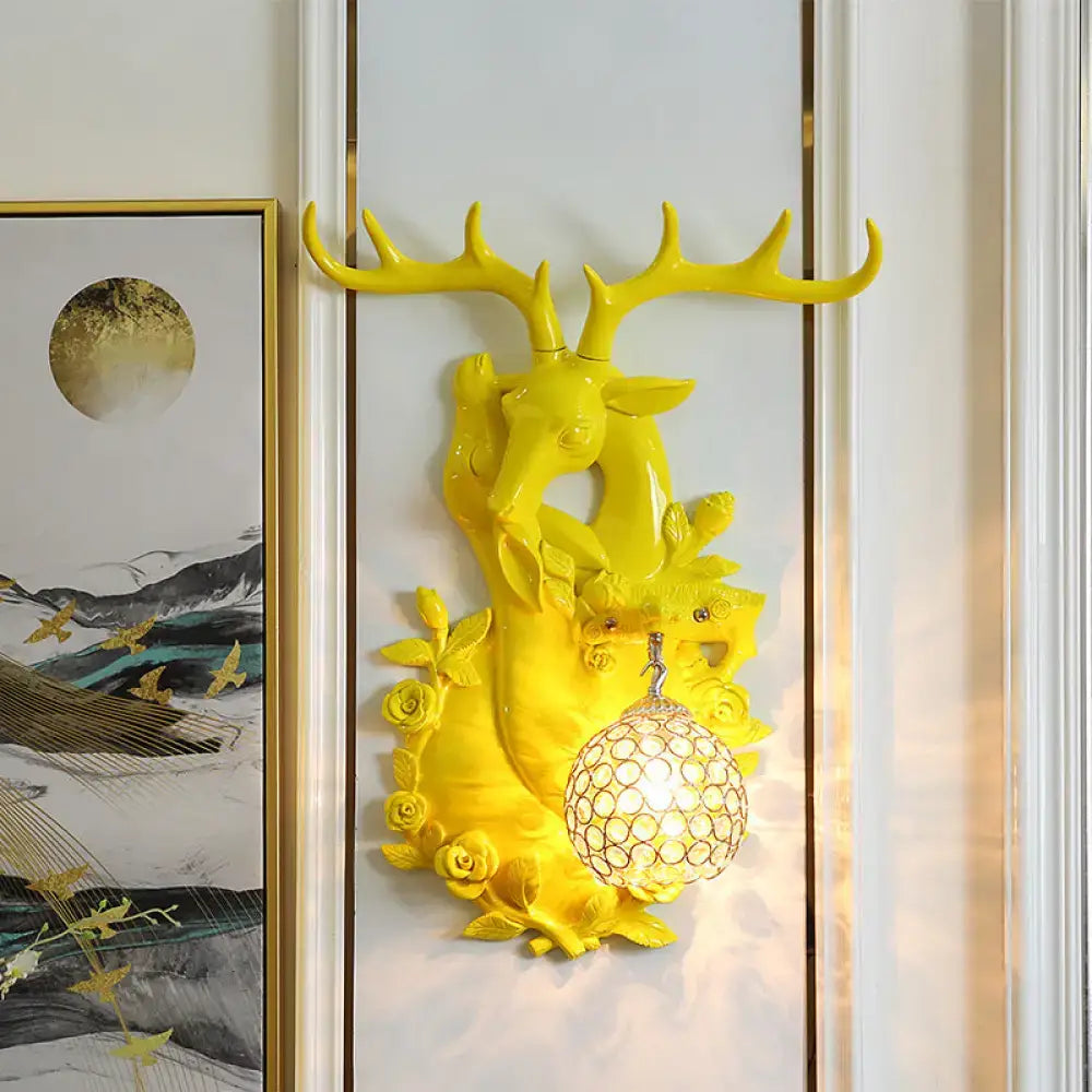 Vibrant yellow deer head accent floral sconce with crystal globe light fixture for bedroom wall lighting