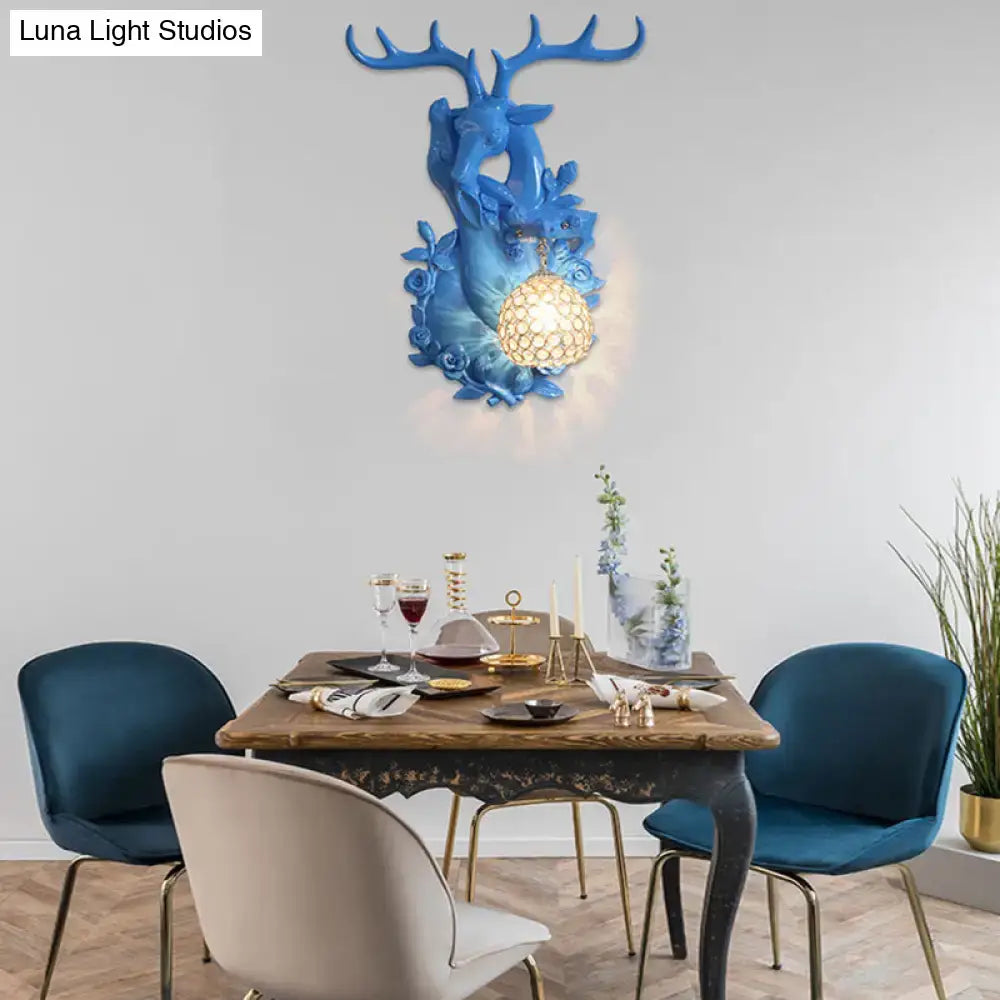 Blue deer head accent wall sconce with textured golden globe light fixture for vibrant yellow floral bedroom decor