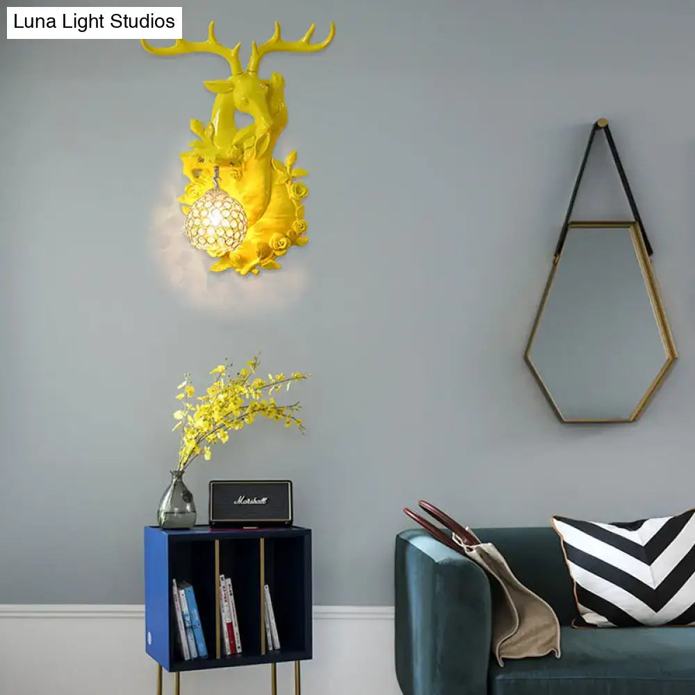 Bright yellow deer head accent wall sconce with crystal globe light fixture for vibrant bedroom decor
