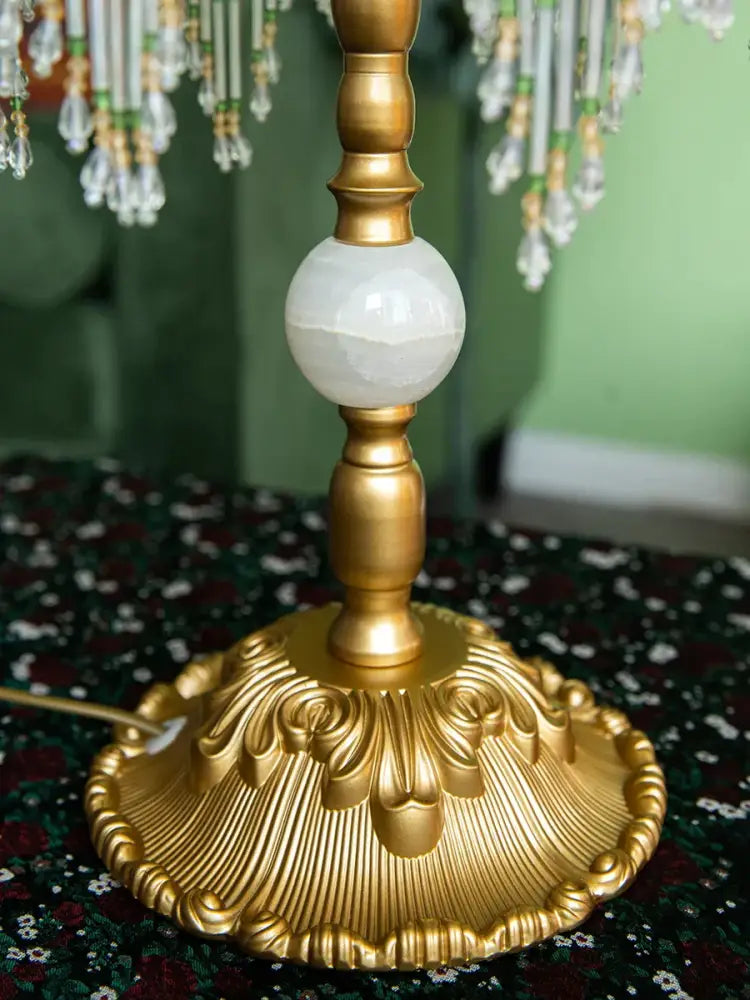 Golden ornate table lamp base with polished white onyx sphere and leaf detailing for crescent moon lampshade decorbites