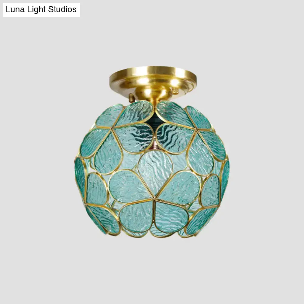A DecorBites Victorian stained glass flower ceiling fixture with turquoise textured glass and gold metal frame