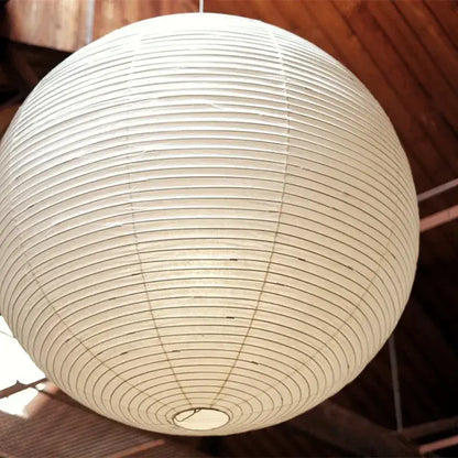 Vintage akari rice paper pendant light with off-white spherical design and concentric ridges for bedroom or living room