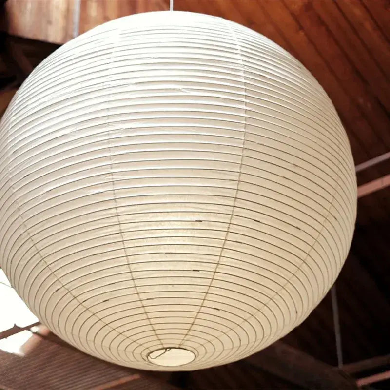 Vintage akari rice paper pendant light with off-white spherical design and concentric ridges for bedroom or living room
