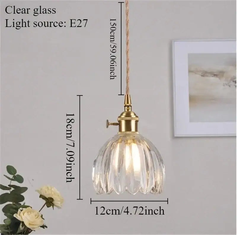 Clear glass pendant light with brass finish and ribbed design featuring iron finish for dining room use