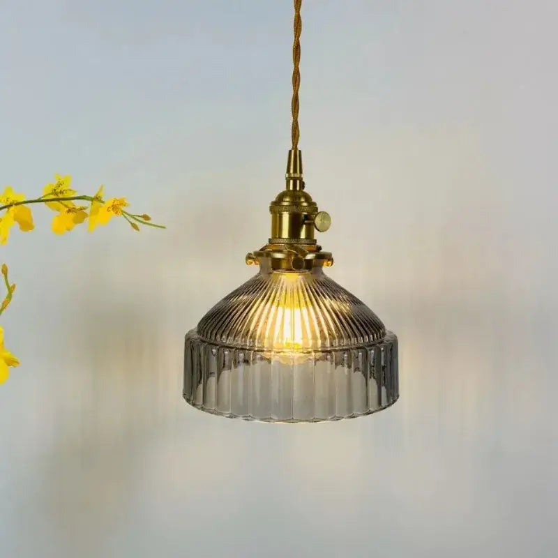 Vintage amber colored glass pendant light with brass fixture and ribbed glass shade for dining room illumination