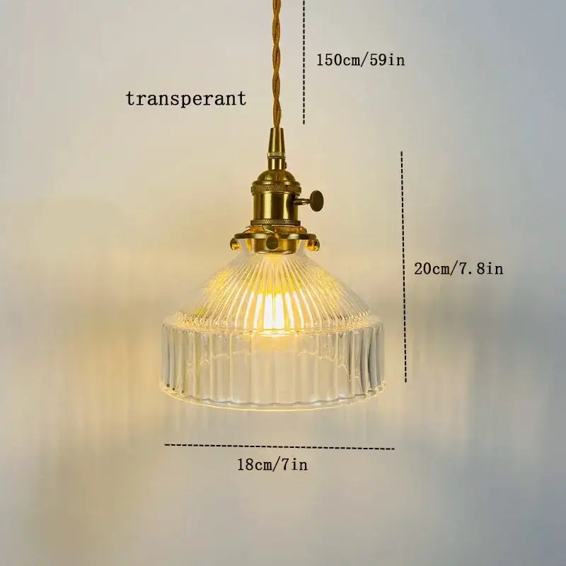 Vintage amber colored glass pendant light with ribbed glass shade and brass hardware ideal for dining room lighting