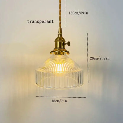 Vintage amber colored glass pendant light with ribbed glass shade and brass hardware ideal for dining room lighting