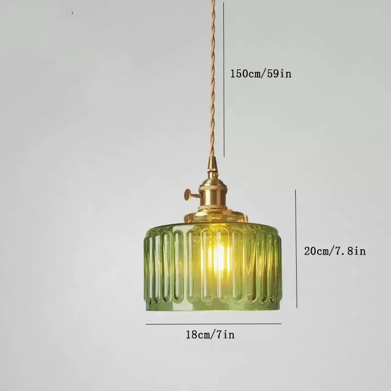 Vintage green ribbed glass pendant light with brass hardware and twisted cord featuring colored glass design