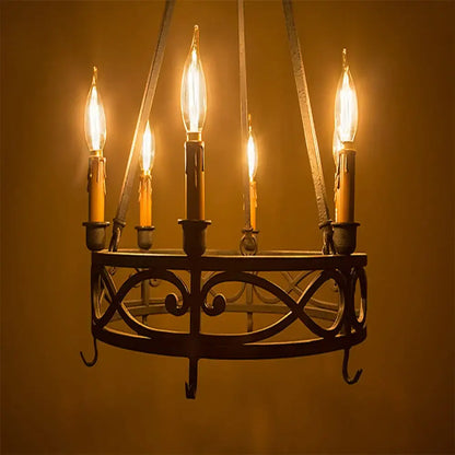 Wrought iron chandelier with five glowing vintage amber dimmable led filament bulbs and ornate scrollwork design for dining room decorbites dimmable led