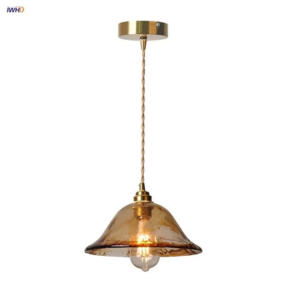 Vintage amber glass adjustable pendant light with brass finish and twisted cord for dining room lighting