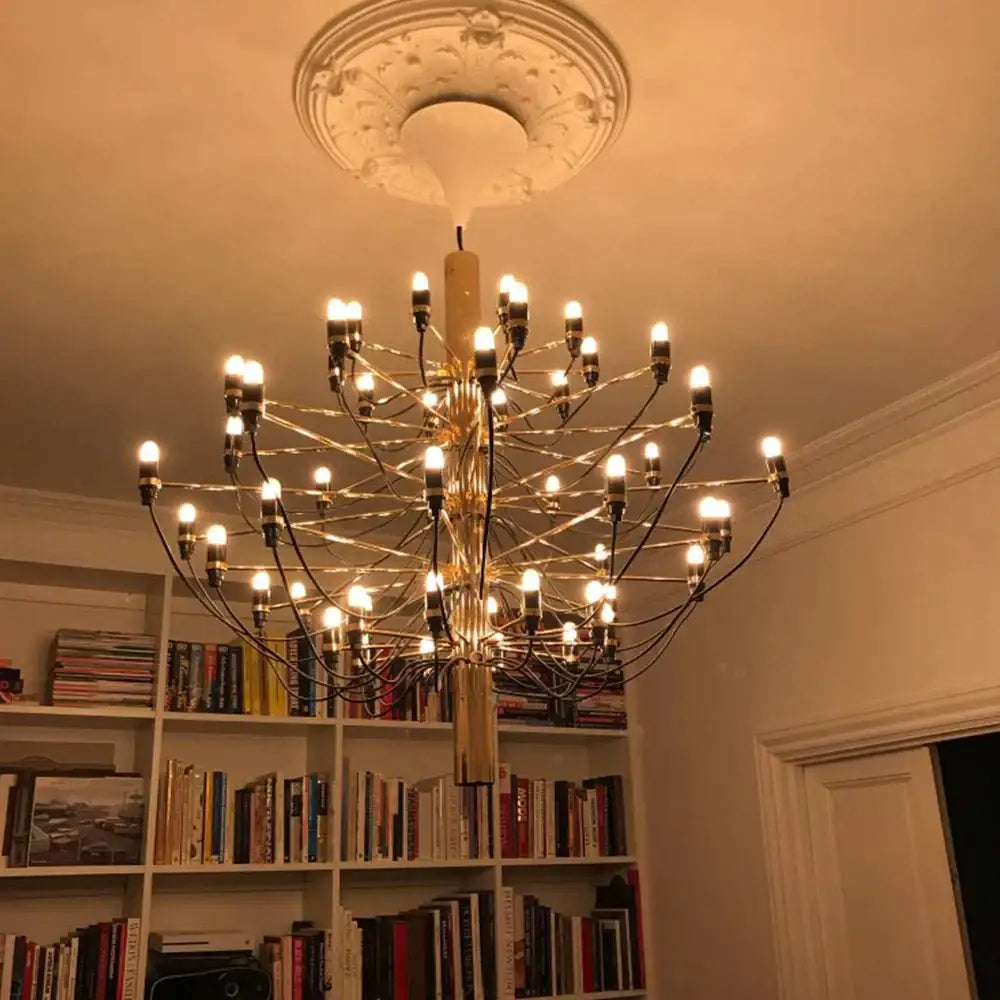 A golden multi-armed chandelier with vintage amber glass led filament bulbs and black cords for bedroom dimmable decorbites lighting