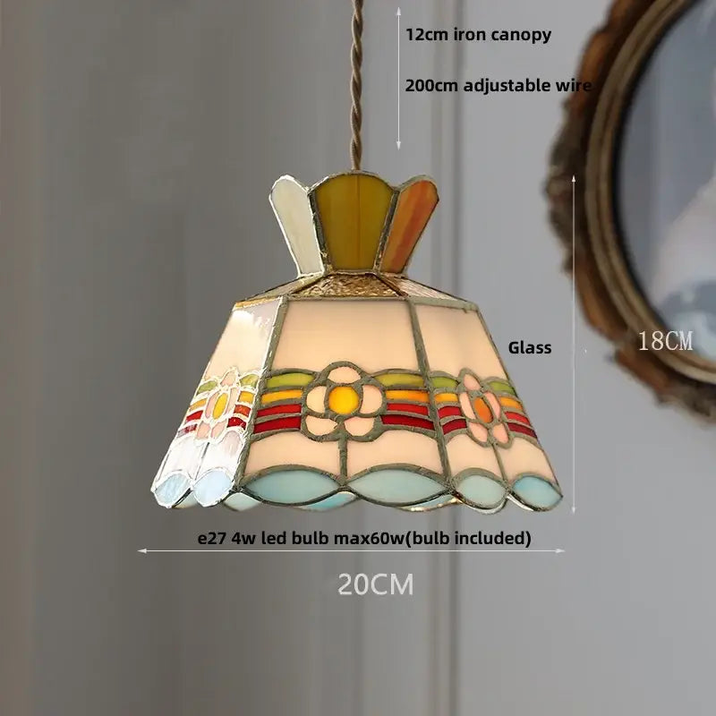 Vintage amber glass led pendant light with colorful stained glass floral design in an ornate metal frame for dining room