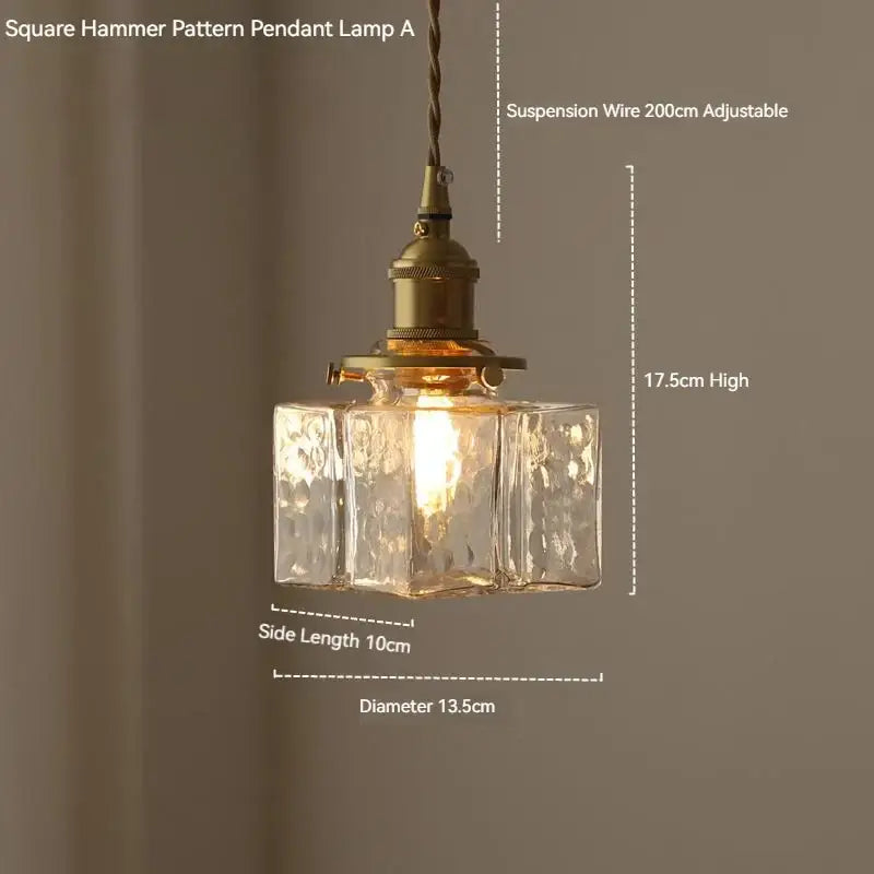 Vintage amber glass pendant light with antique brass finish and square hammer-patterned glass pendant shade for dining room