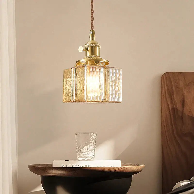 Vintage amber glass pendant light with gold-toned brass and textured amber glass panels for dining room use