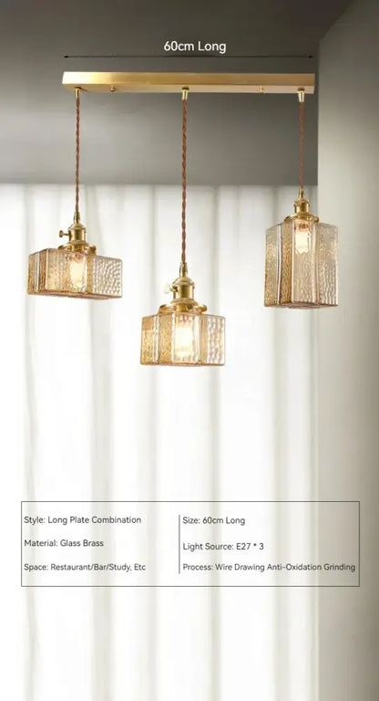 Vintage amber glass pendant light with gold-toned brass textured glass pendant lights on a 60cm bar for dining room