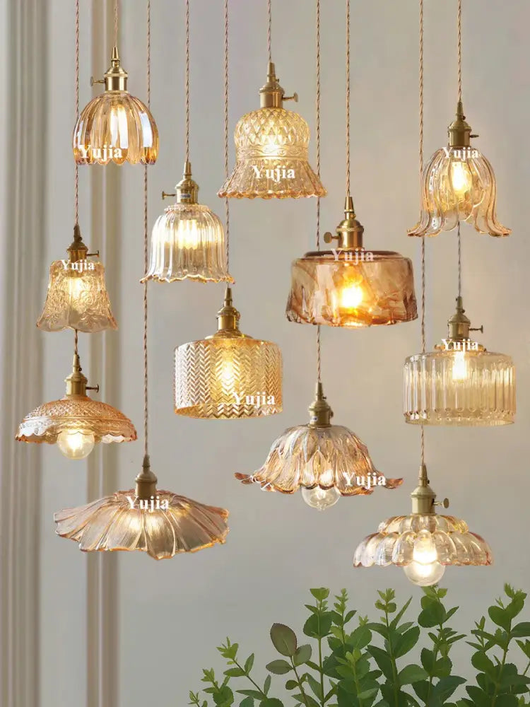 A vintage amber glass pendant light with brass fixtures and intricate patterns for kitchen island lighting