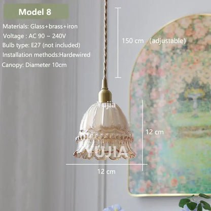 Delicate amber glass pendant light with fluted design and brass accents hanging from adjustable cord for kitchen island