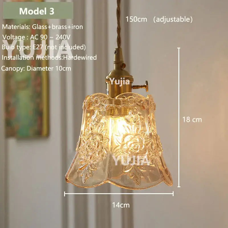 A vintage amber glass pendant light with floral etchings and brass fixture for a kitchen island model 3
