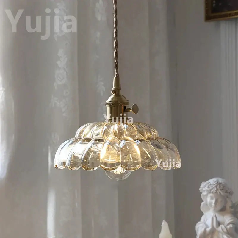 Vintage amber glass pendant light with brass finish and scalloped shade for kitchen island lighting