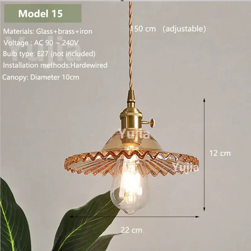 Vintage amber glass pendant light with brass fixture and scalloped edge designed for kitchen island lighting
