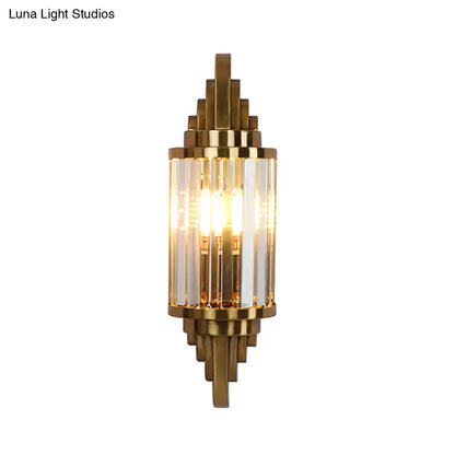 Gold-toned vintage art deco wall sconce with clear crystal prism rods and geometric metal framing for living room use