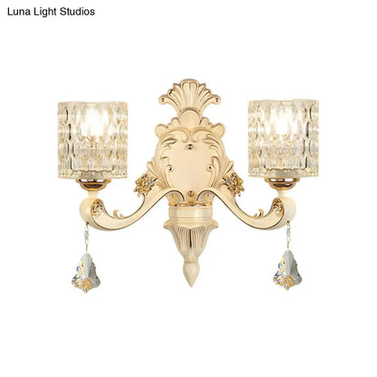 Elegant cream-colored vintage glass wall light with ornate design, crystal-cut glass shades, and faceted crystal pendants