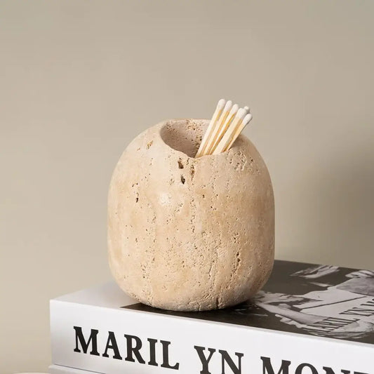 Beige travertine match holder with a rustic textured stone surface for living room decor by decorbites