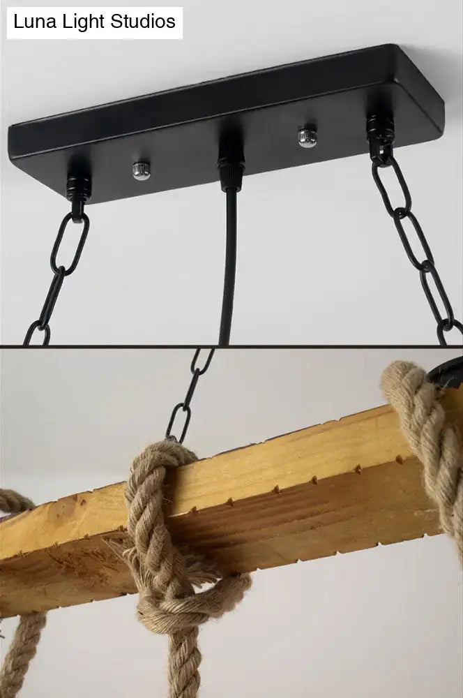 Black metal rectangular ceiling fixture with three chains and beige wooden beam wrapped in thick rope for kitchen island lighting