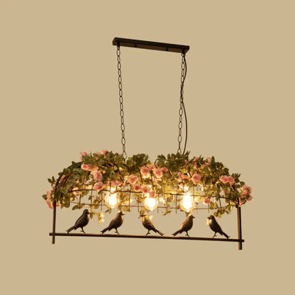 Vintage bird cage iron hanging light with black metal frame, pink roses, green foliage, and five bird figurines