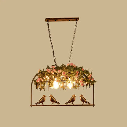 Vintage bird cage iron hanging light with rustic bronze bird pendant, wooden top, pink roses, and greenery for dining room