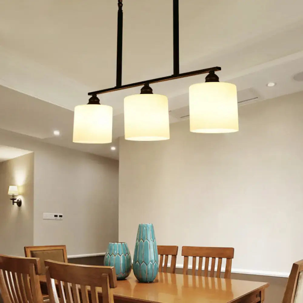 Vintage black metal bar island light with three off-white fabric shades for dining room white glass decor