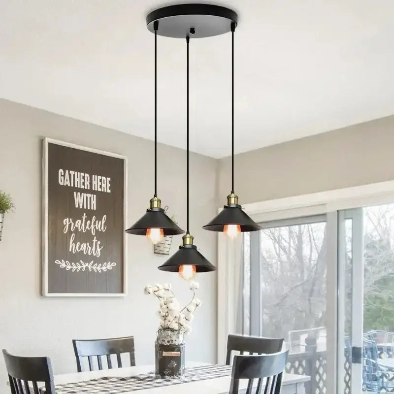 Vintage black and brass metal pendant light with black metal finish and conical shades for kitchen island lighting