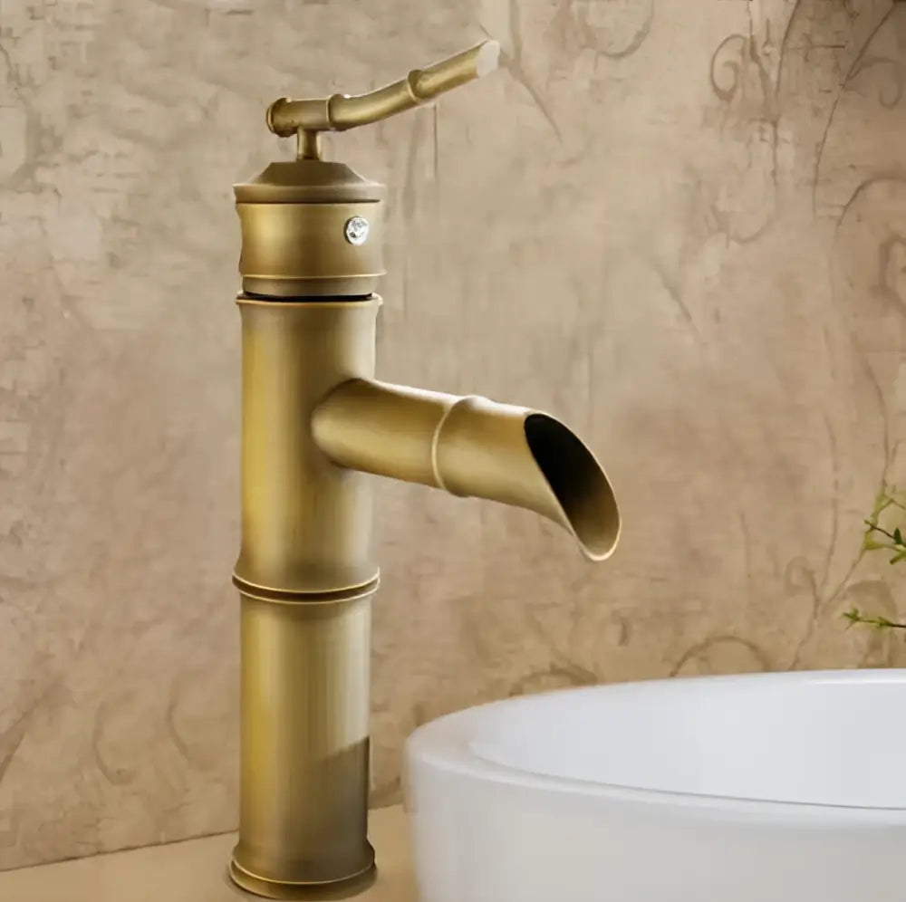 Antique brass vintage bathroom faucet with bamboo-style design and curved spout for bathroom sink use